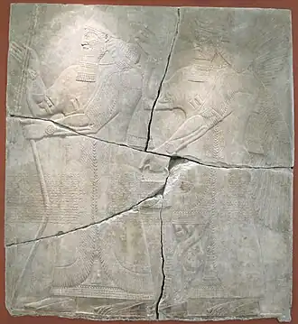 Выдающийся полководец и дипломат IX века до н. э. Ашшур-нацир-апал II в сопровождении божества. Рельеф из его дворца в Кальху. Эрмитаж (Санкт-Петербург)