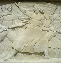 Деталь с каменного барельефа перед входом на кладбище